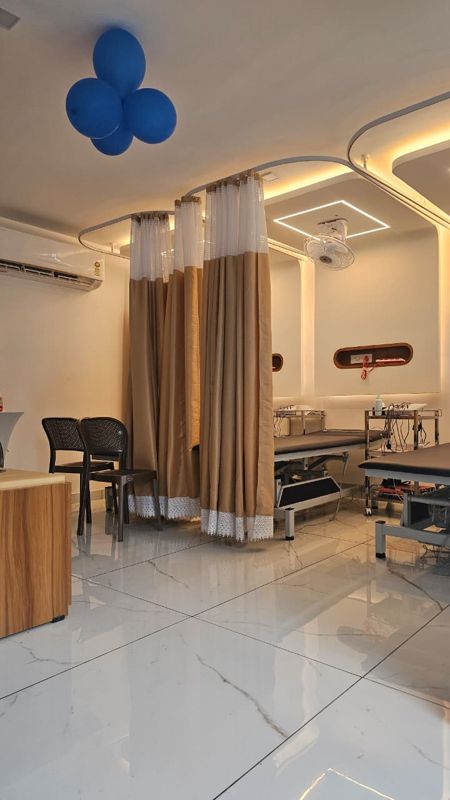 Electrotherapy treatment beds with curtains in the physiotherapy clinic at Pranah, Moonnuperiya