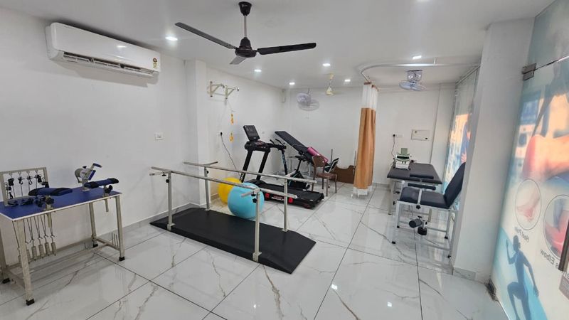 Physiotherapy exercise room with parallel bars, treadmill and Swiss balls at Pranah Kannur